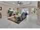 Spacious living room with tile flooring, recessed lighting, ceiling fan, and sliding glass doors to the lanai at 171 Birchmont Dr, Deland, FL 32724