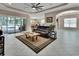 Bright living room featuring tile flooring, a large fan, recessed lighting, and sliding glass door access at 171 Birchmont Dr, Deland, FL 32724