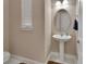 Charming powder room featuring a pedestal sink, oval mirror, and neutral wall color at 171 Birchmont Dr, Deland, FL 32724