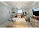 Bright bedroom featuring stylish decor, modern furniture, a plush bed, and large windows with neutral paint at 1759 Copinger Ter, Kissimmee, FL 34744