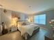 Beautiful bedroom featuring neutral paint, updated flooring, stylish furniture and decor, and a large window for natural light at 1759 Copinger Ter, Kissimmee, FL 34744
