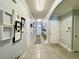 Inviting hallway features decorative art, tile flooring, arched doorway, and access to multiple rooms at 1759 Copinger Ter, Kissimmee, FL 34744