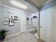 Well-lit hallway with tile flooring, decorative artwork, and access to various rooms for convenience and privacy at 1759 Copinger Ter, Kissimmee, FL 34744