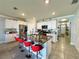 Modern kitchen with granite counters, stainless appliances, island seating, and tiled backsplash at 1759 Copinger Ter, Kissimmee, FL 34744