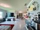 Open-concept living room showcasing a modern bar area, comfortable seating, and seamless flow to kitchen and dining at 1759 Copinger Ter, Kissimmee, FL 34744