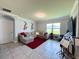 Cozy living room with natural light, tile flooring, comfortable seating, and musical artwork for relaxation at 1759 Copinger Ter, Kissimmee, FL 34744