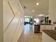 Open floorplan showcasing living room with plenty of sunlight, flowing to dining area, kitchen, and backyard at 1759 Copinger Ter, Kissimmee, FL 34744