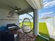 Relaxing covered patio featuring a unique hanging chair, outdoor seating, and a view of the manicured backyard at 1759 Copinger Ter, Kissimmee, FL 34744