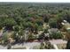 An aerial view outlining property lines, showcasing wooded acreage with the home visible in the corner at 1880 N Sparkman Ave, Orange City, FL 32763