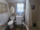 Bathroom equipped with a toilet, sink, and shower, featuring a neutral color scheme at 1880 N Sparkman Ave, Orange City, FL 32763