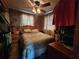 Bedroom featuring a comfortable bed, side tables, and a ceiling fan for added comfort at 1880 N Sparkman Ave, Orange City, FL 32763