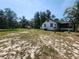 Exterior view of the home, showing the screened porch and detached storage shed at 1880 N Sparkman Ave, Orange City, FL 32763