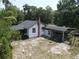 A home with a chimney and carport viewed from an aerial perspective at 1880 N Sparkman Ave, Orange City, FL 32763