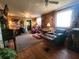 Comfortable living room with wood floors, ceiling fans, brickwork and a cozy seating area at 1880 N Sparkman Ave, Orange City, FL 32763