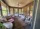 Charming enclosed porch with wicker furniture and inviting decor at 1880 N Sparkman Ave, Orange City, FL 32763