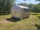 Exterior angle of a metal storage shed with double doors and surrounding grass at 1880 N Sparkman Ave, Orange City, FL 32763