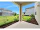 View from the covered patio to the yard and nearby fenced-in swimming pools at 1923 Mendocino Ln, Port Orange, FL 32128