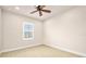 This bedroom features neutral walls, carpeted floors, and a ceiling fan at 1923 Mendocino Ln, Port Orange, FL 32128