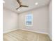 A vacant bedroom with neutral carpeting, a ceiling fan, and a window at 1923 Mendocino Ln, Port Orange, FL 32128