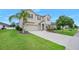 Charming two-story home with a manicured lawn, mature landscaping, and a two-car garage at 1923 Mendocino Ln, Port Orange, FL 32128