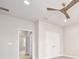 This hallway features neutral walls and a view to a bedroom with plantation shutters at 1923 Mendocino Ln, Port Orange, FL 32128