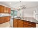 Bright kitchen features wood cabinets, granite countertops, stainless steel appliances, and an open floorplan at 1923 Mendocino Ln, Port Orange, FL 32128