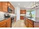 Modern kitchen with stainless steel appliances, granite countertops, and a stylish backsplash at 1923 Mendocino Ln, Port Orange, FL 32128