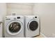 This laundry room features a modern white washer and dryer at 1923 Mendocino Ln, Port Orange, FL 32128