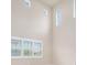 Bright living room featuring plantation shutters, soaring ceilings, and tile floors at 1923 Mendocino Ln, Port Orange, FL 32128