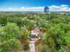 Aerial view of a house surrounded by greenery, with a cityscape visible in the background at 200 Alpine St, Altamonte Springs, FL 32701