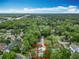 Aerial view of a home surrounded by lush greenery and trees under a bright blue sky at 200 Alpine St, Altamonte Springs, FL 32701