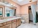 The well-lit bathroom has a double sink vanity, a large mirror, and a separate closet at 200 Alpine St, Altamonte Springs, FL 32701