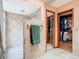 Bathroom showing tile shower with dual shower heads and mirrored closet with clothes at 200 Alpine St, Altamonte Springs, FL 32701