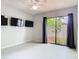 This bedroom has three TVs on the wall and a sliding door with a lovely garden view at 200 Alpine St, Altamonte Springs, FL 32701