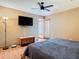 Comfortable bedroom with ceiling fan, mounted TV, and sliding doors to the outside at 200 Alpine St, Altamonte Springs, FL 32701