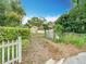 Gated driveway leading to a home surrounded by lush greenery at 200 Alpine St, Altamonte Springs, FL 32701