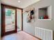 Entryway featuring a sliding glass door, tile floors, coat rack, and a built-in niche at 200 Alpine St, Altamonte Springs, FL 32701
