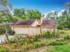 Exterior view of a home with a garage surrounded by mature landscaping at 200 Alpine St, Altamonte Springs, FL 32701