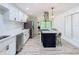 Bright kitchen featuring white cabinets, stainless steel appliances, and an island with bar stool seating at 200 Alpine St, Altamonte Springs, FL 32701