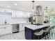 Modern kitchen with white cabinets, stainless steel appliances, and a stylish island with seating at 200 Alpine St, Altamonte Springs, FL 32701