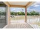 Tile balcony overlooking landscaped areas with parking and residential buildings at 201 Dyson Dr, Deland, FL 32724