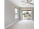Neutral bedroom with carpet flooring, natural light, and sliding glass doors at 201 Dyson Dr, Deland, FL 32724