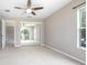 Neutral bedroom features a ceiling fan and large closet with mirrored sliding doors at 201 Dyson Dr, Deland, FL 32724