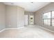 Spacious bedroom with neutral carpet, baseboard trim, and door to the outdoor space at 201 Dyson Dr, Deland, FL 32724