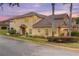 Two-story tan stucco home with lush landscaping, palm trees, and an attached two-car garage at 201 Dyson Dr, Deland, FL 32724