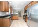 Open kitchen with stainless steel appliances, granite countertops, and tile flooring at 201 Dyson Dr, Deland, FL 32724