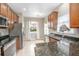 Bright kitchen features stainless steel appliances, granite countertops, and wooden cabinetry at 201 Dyson Dr, Deland, FL 32724