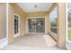Covered patio with brick flooring and screen, leading to outdoor living space at 201 Dyson Dr, Deland, FL 32724