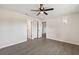 Spacious bedroom with a ceiling fan, light gray flooring, and access to multiple closets and entryways at 2106 Umbrella Tree Dr, Edgewater, FL 32141