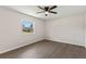 Bright, minimalist bedroom boasts light gray flooring, neutral walls, and a large window for ample natural light at 2106 Umbrella Tree Dr, Edgewater, FL 32141